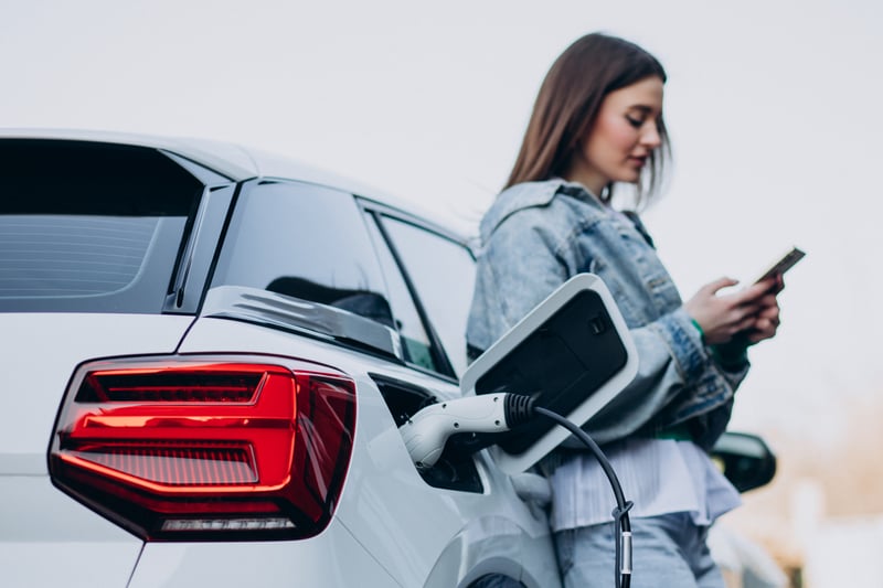 woman-charging-her-electric-car-with-charging-pistol